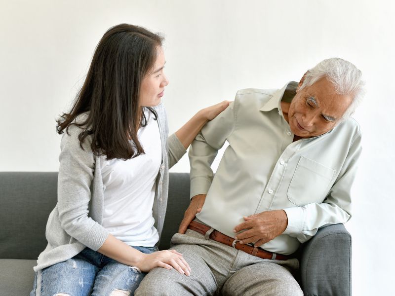 A daughter with her father wondering about hip joint treatment.