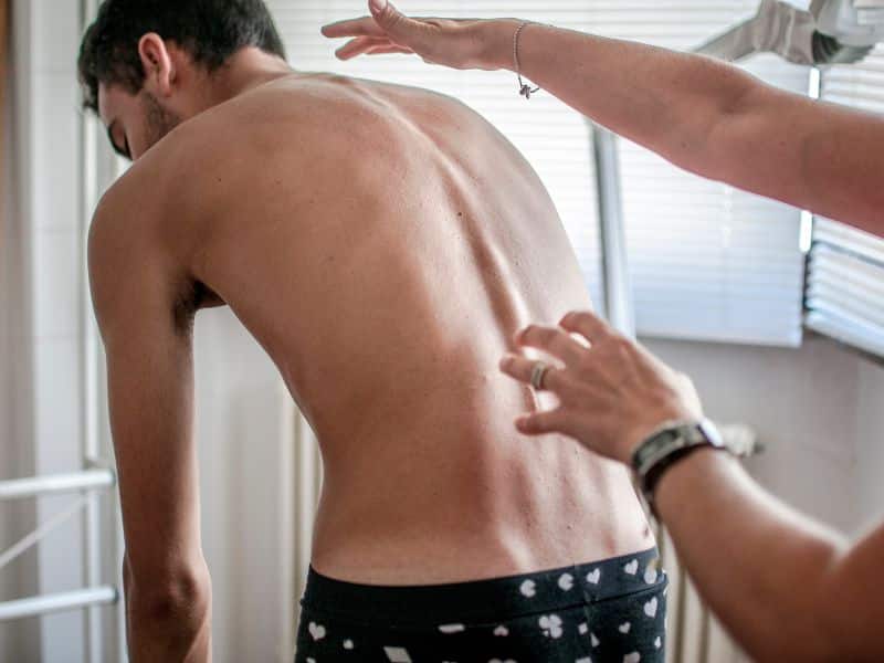 A man experiencing scoliosis hip pain in the U.S. Virgin Islands.