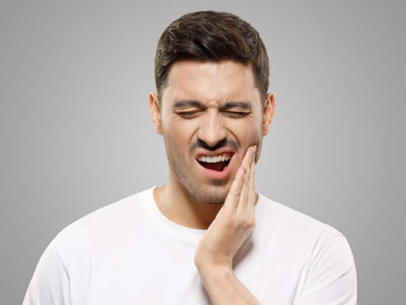 A man with TMJ symptoms that are causing neck and jaw pain.