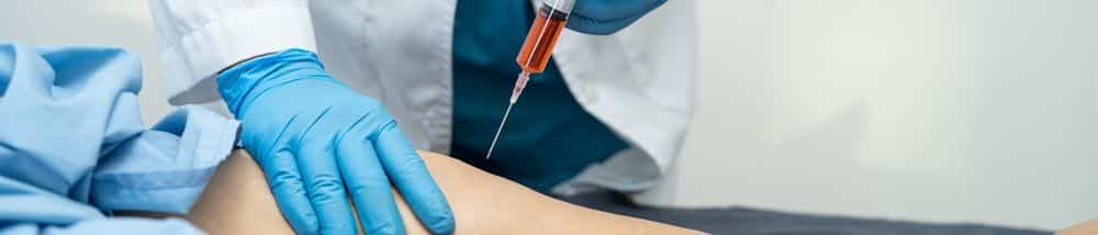 A patient receiving a knee pain injection at Virgin Islands Neurology.