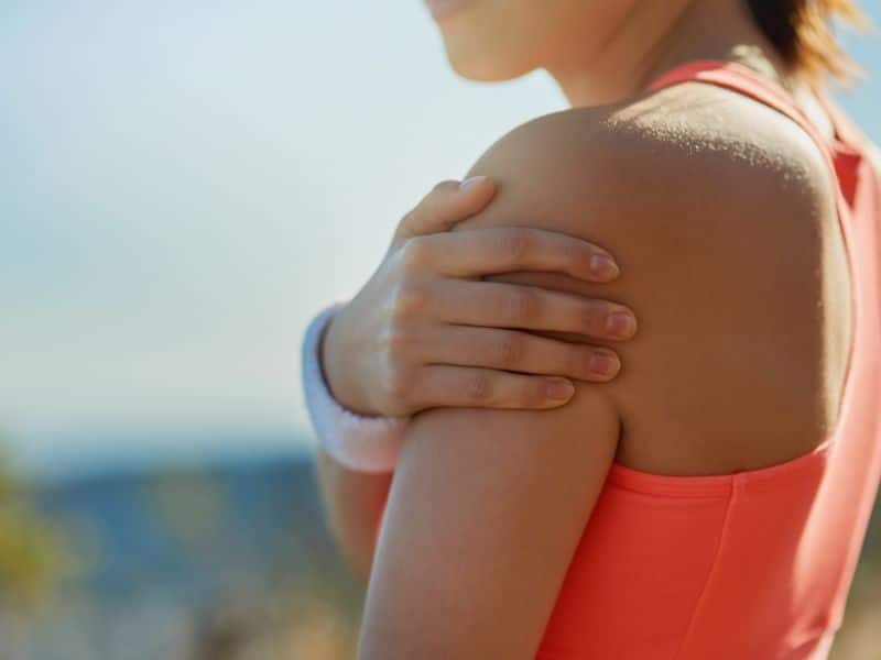 A woman feeling shoulder pain in the U.S. Virgin Islands.