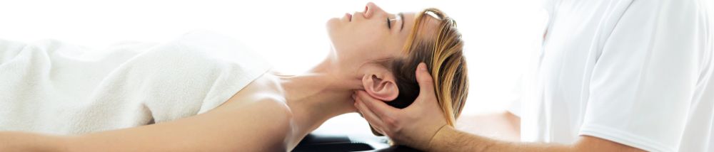 A woman getting physical therapy as a treatment for her whiplash headaches.