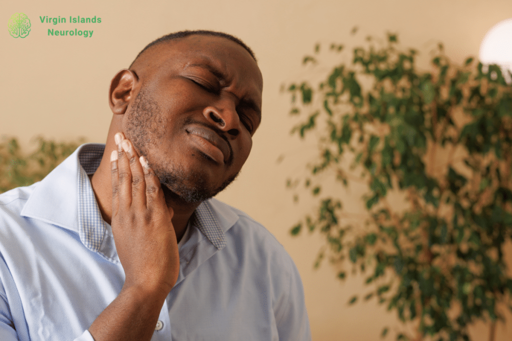 A man with pain in his jaw and neck caused by a TMJ disorder in the U.S Virgin Islands.