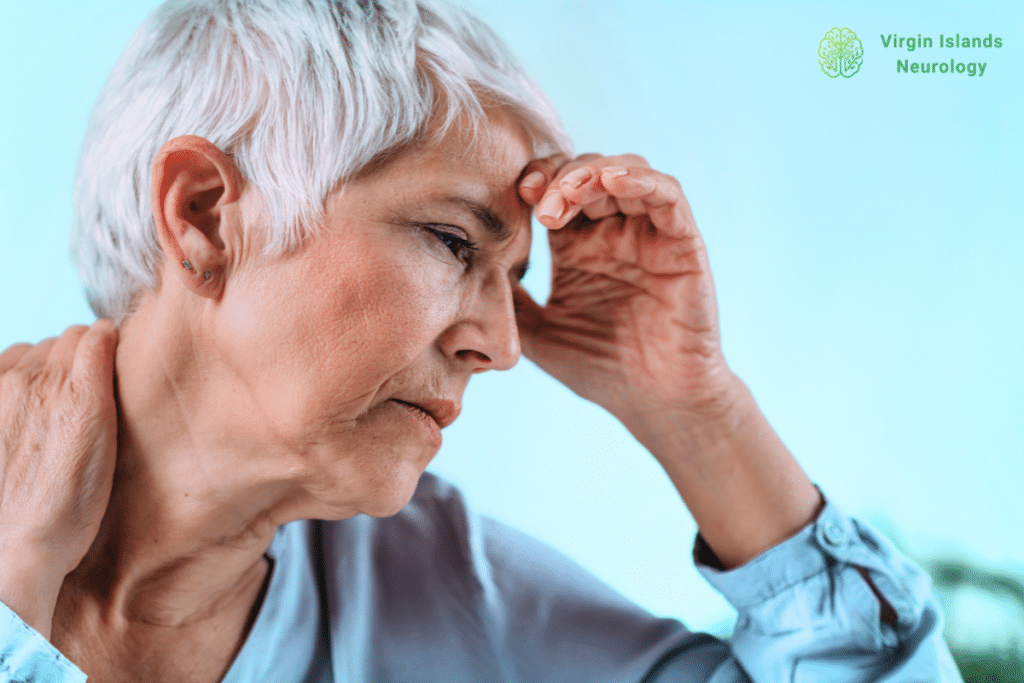 An older woman experiencing a headache and neck stiffness caused by a pinched nerve in the U.S Virgin Islands.